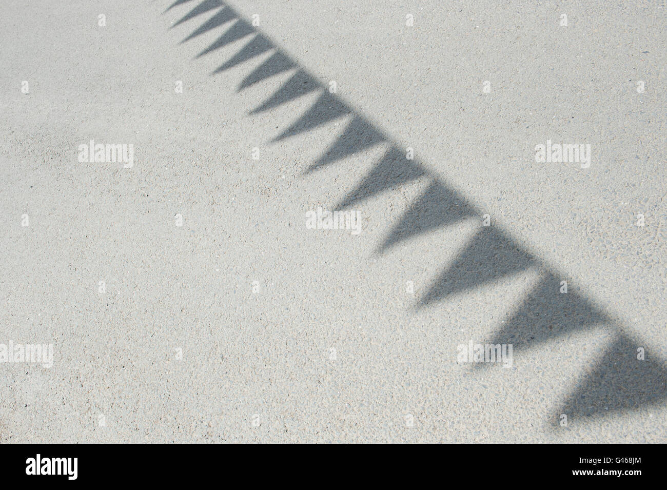 Fabric bunting shadows on a road in the cotswolds. UK Stock Photo