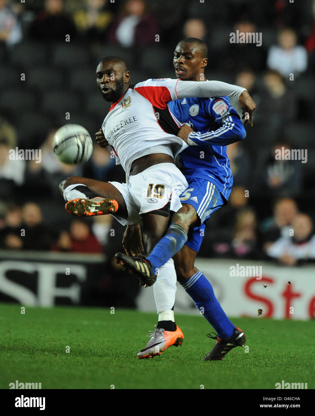 Milton Keynes Dons' Jabo Ibehre and Peterborough United's Gabriel Zakuani Stock Photo