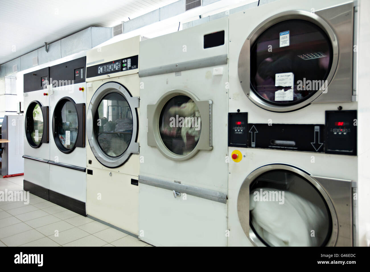 Automatic washing machines in laundrette Stock Photo