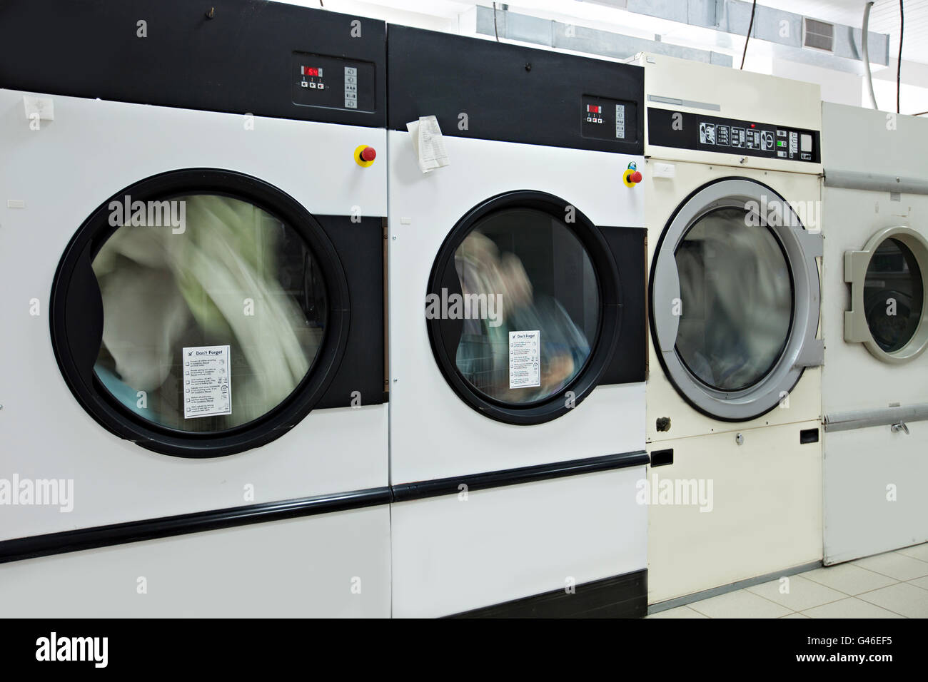 Running washing machines in laundry room Stock Photo Alamy