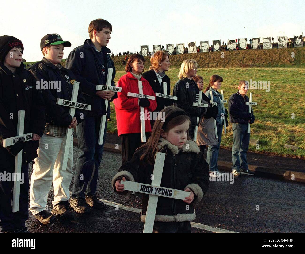 Remembering the victims of Bloody Sunday, marchers carry crosses and