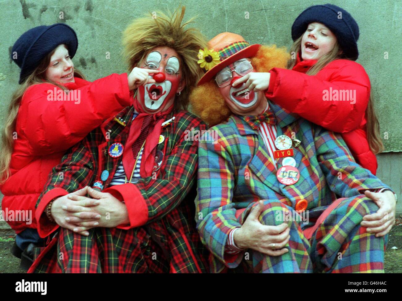 Ten-year-old twins Nicky (l) and Sarah (r) Amey 'clown' around with Kiku (cen l) and Dez Colona as part of the annual Grimaldi service in London's East End today (Sun) to celebrate the life of Joseph Grimaldi. Photo by Fiona Hanson/PA. Stock Photo