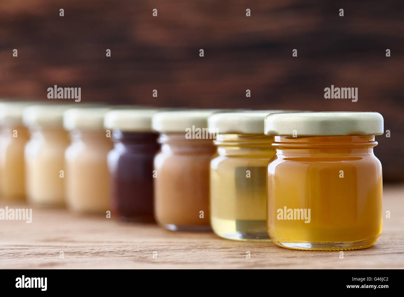 Different kinds of honey in a row Stock Photo Alamy