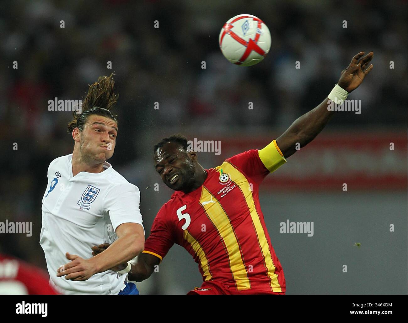 Soccer - International Friendly - England v Ghana - Wembley Stadium. England's Andrew Carroll (left) and Ghana's John Mensah battle for the ball Stock Photo