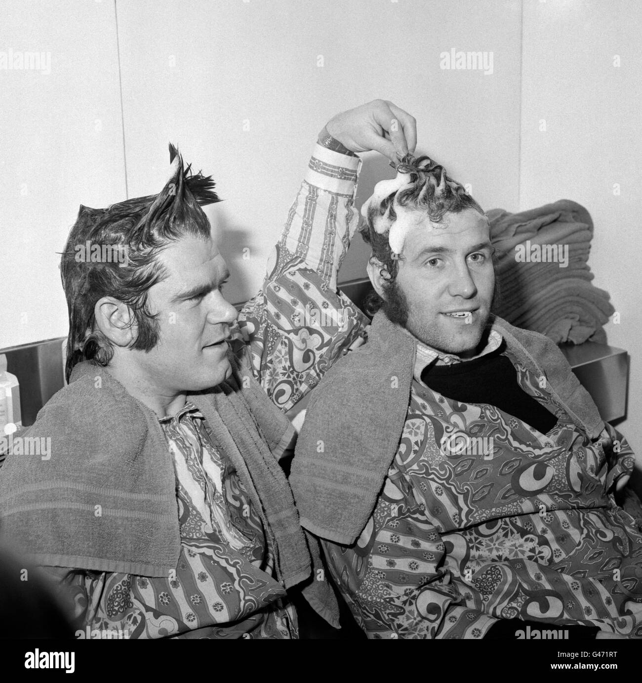 Chelsea stars David Webb (l) and Peter Osgood (r) pictured at Vidal Sassoon's Belgravia Salon. The society hairstylist, an ardent Chelsea fan, promised the players a free haircut should they reach the League Cup Final. Chelsea however would go on to lose the final 2-1 to Stoke City. Stock Photo