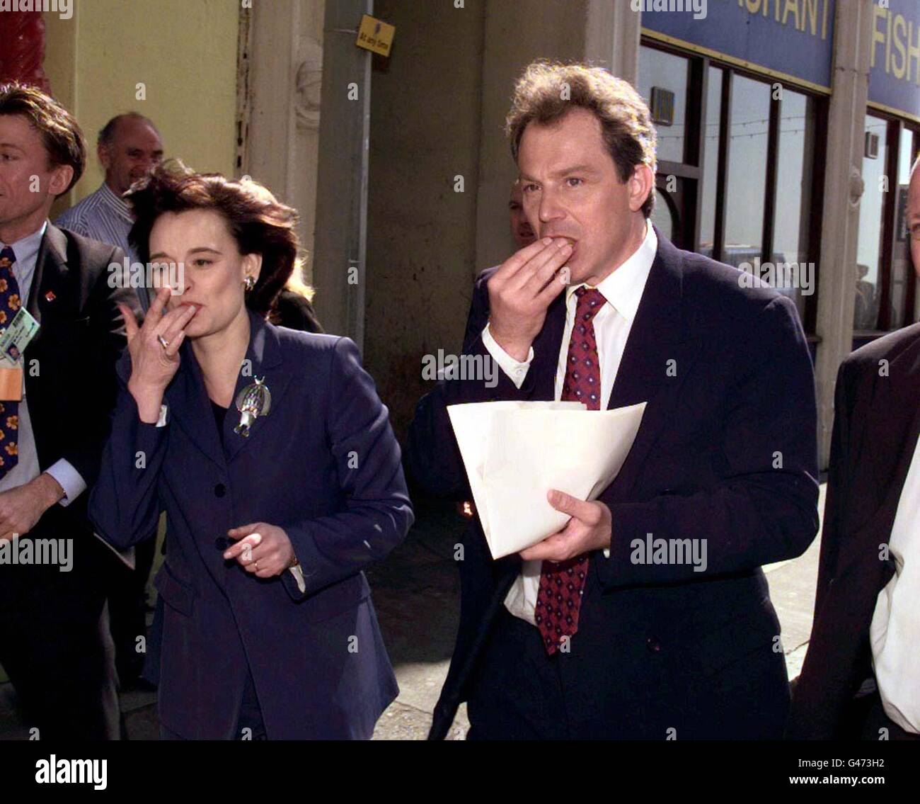 Labour leader Tony Blair and his wife Cherie Booth eat a bag of chips