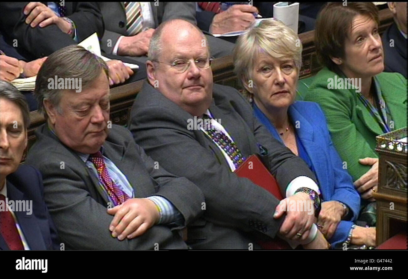 Secretary of State for Justice Kenneth Clarke (left) and Secretary of State for Communities and Local Government Eric Pickles listen to Chancellor George Osborne deliver his Budget in the House of Commons, London. Stock Photo