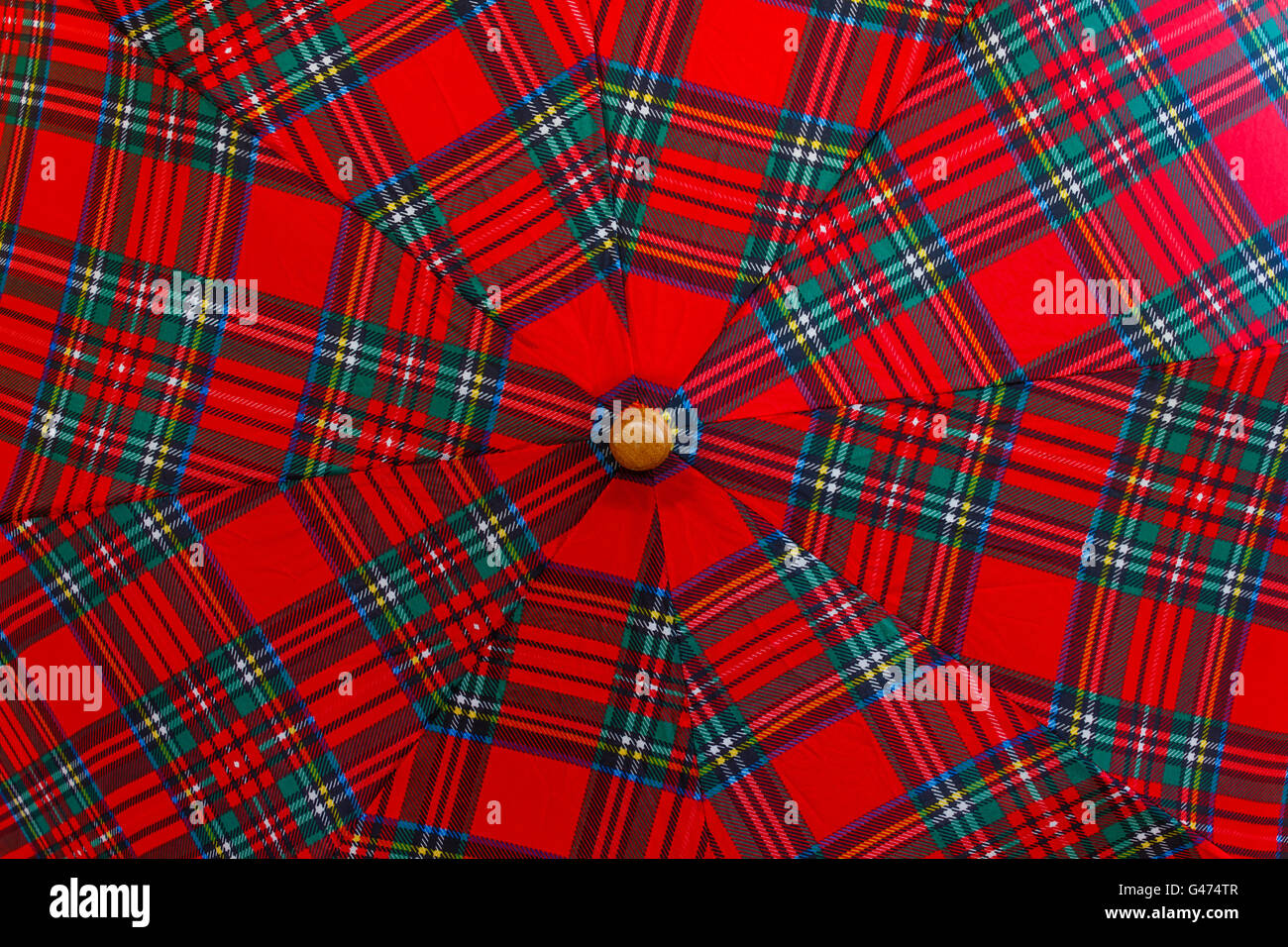 multicoloured wedges umbrella seem a vortex of colours Stock Photo