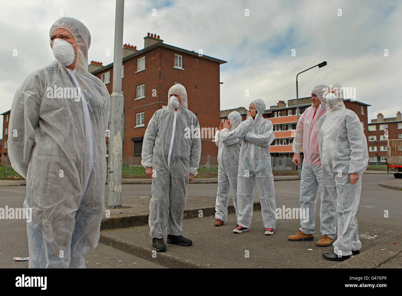 Residents of Dolphin House protest dressed in Bio Hazard suits to illustrate the ongoing problems with damp and sewerage in the council housing development in south Dublin. Stock Photo