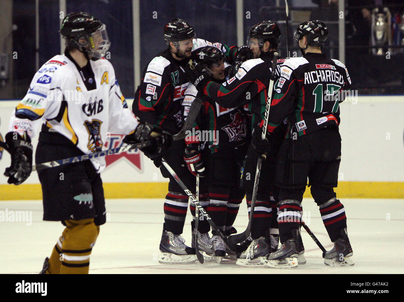 Cardiff Devils Jon Pelle (hidden) is congratulated by team-mates after scoring Stock Photo