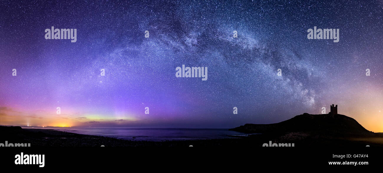 Lilburn Tower/Dunstanburgh Castle with the Milky Way and Northern Lights Stock Photo