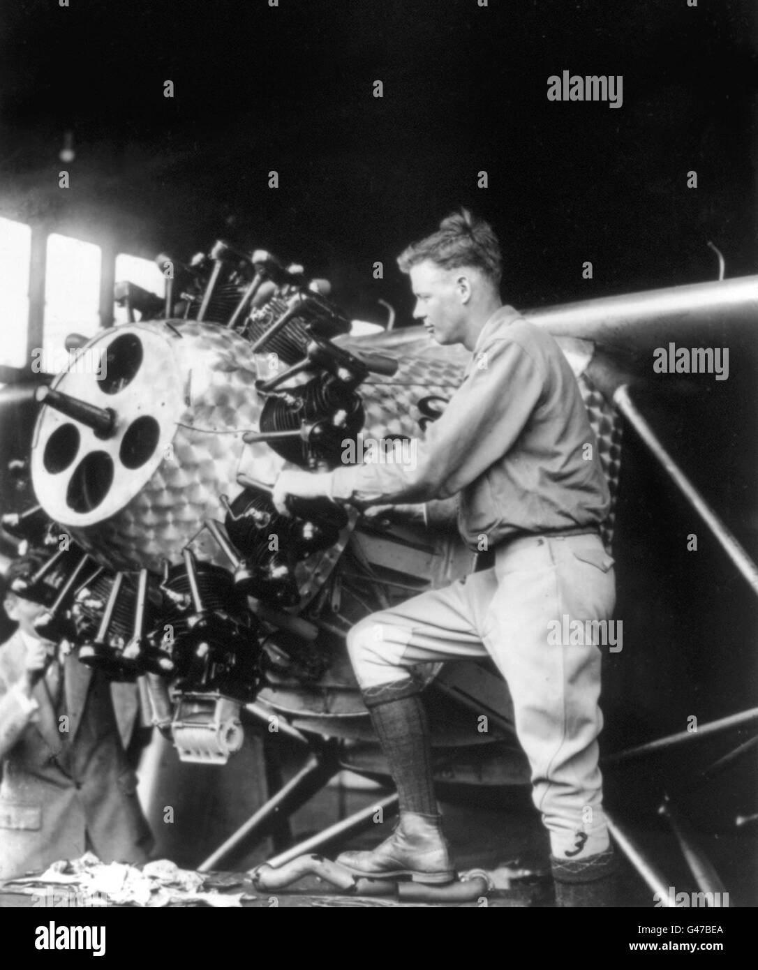 Charles Lindbergh (1902-1974) working on the engine of his airplane 'Spirit of St. Louis'. Photo c.1927. Stock Photo