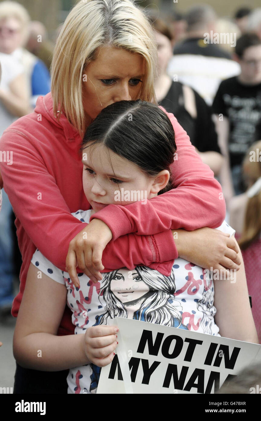 A mother and daughter join thousands of people gathered in Omagh for a peace walk to mark the death of Northern Ireland police officer Ronan Kerr, who was killed in a car bomb explosion. Stock Photo
