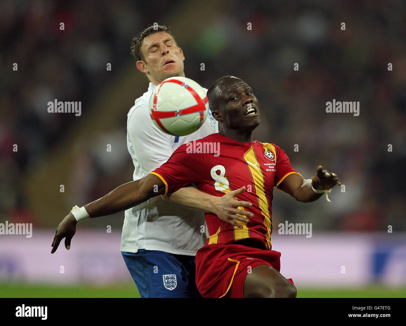 Soccer - International Friendly - England v Ghana - Wembley Stadium. Ghana's Emmanuel Agyemang-Badu (right) and England's James Milner battle for the ball Stock Photo