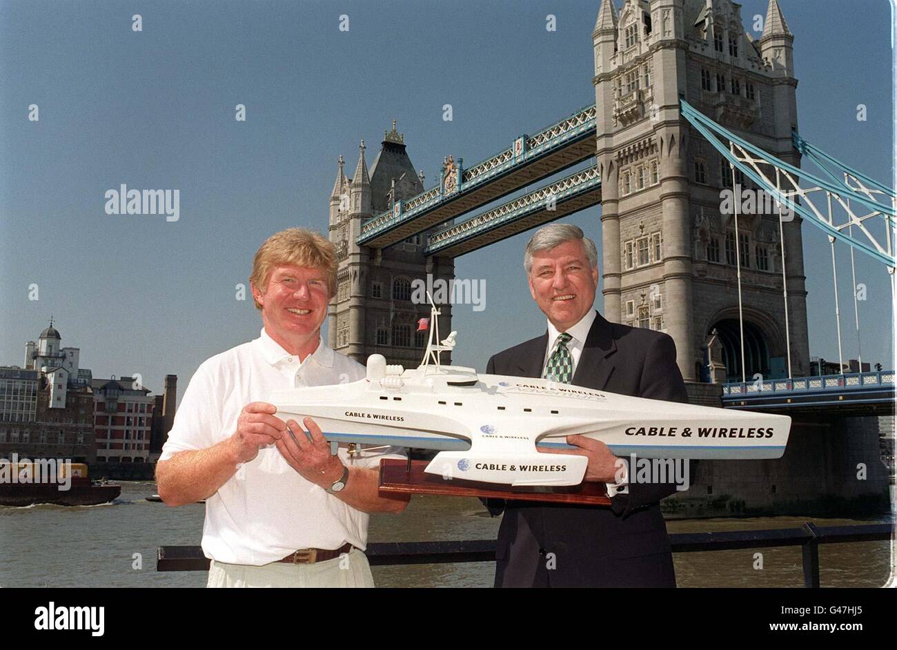 Skipper and leader of the Cable & Wireless Adventure Jock Wishart (left) and Cable & Wireless Chief Executive Richard H. Brown hold a model of the Cable & Wireless, the 115-foot multi-hull powered vessel which will attempt to go around the world in 80 days in 1998. Mr Wishart who will captain the Cable and Wireless on its pioneering 26,000-mile worldwide journey is offering 16 people to join his professional crew of four. Photo by Sam Pearce/PA. Watch for PA Story. Stock Photo