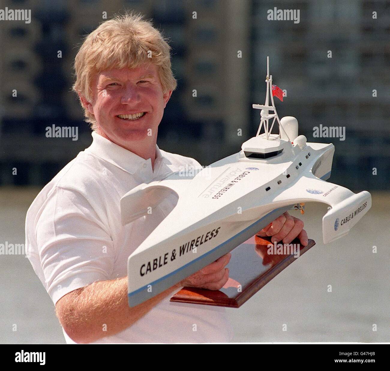 Skipper and leader of the Cable & Wireless Adventure Jock Wishart holds a model of the Cable & Wireless, the 115-foot multi-hull powered vessel which will attempt to go around the world in 80 days in 1998. Mr Wishart who will captain the Cable and Wireless on its pioneering 26,000-mile worldwide journey is offering 16 people to join his professional crew of four. Photo by Sam Pearce/PA. Watch for PA Story. Stock Photo