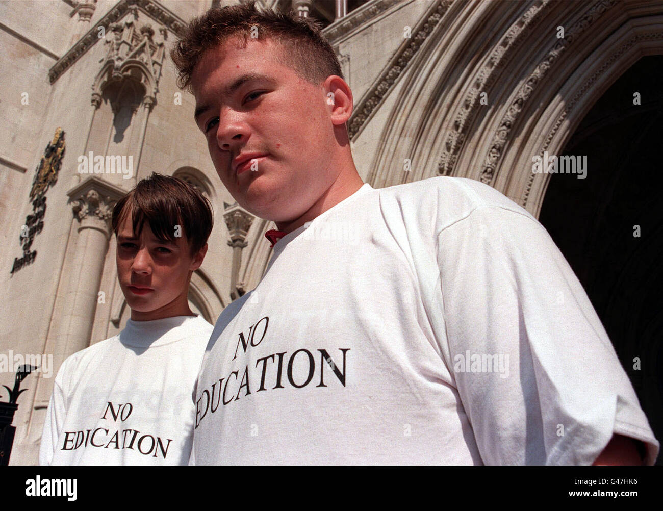 Gary Watts, 15 (left) and David McEvoy, 15 - just two of a large number of children who have 'fallen out of the school system' in Lambeth, south London - outside the High Courts in London today (Tuesday). After both were driven out of their former schools through bullying, Mr Justice Collins has given them leave to seek a judicial review on the grounds that Lambeth council is in breach of its duty under section 19 of the 1996 Education Act if it does not make arrangements for a suitable education for each child. See PA story COURTS School. Photo by Stefan Rousseau/PA. Stock Photo