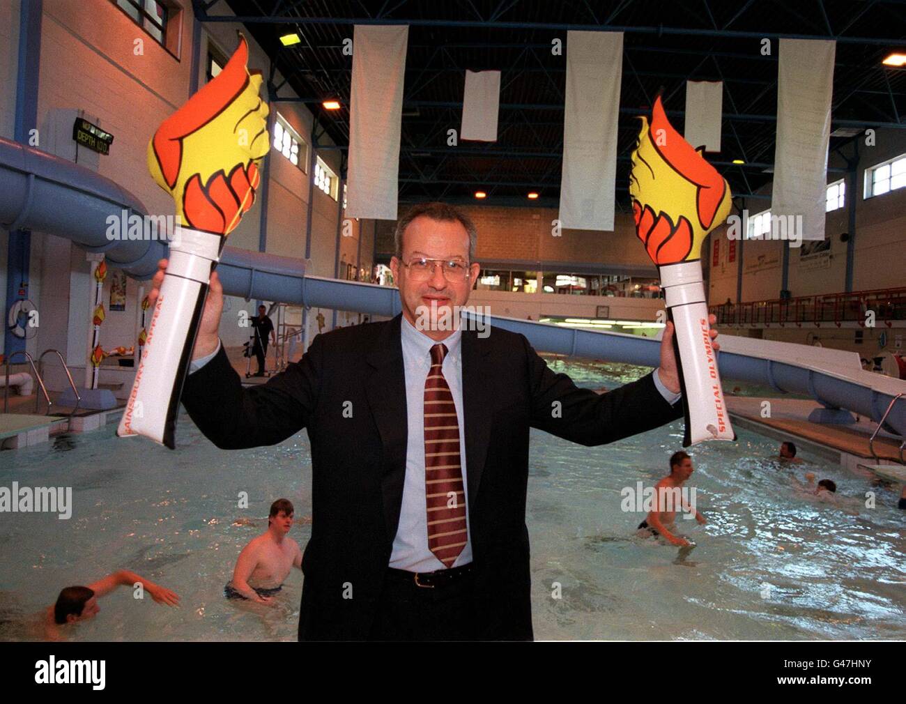 Chairman of J Sainsbury PLC David Sainsbury, holds up a Sainsbury