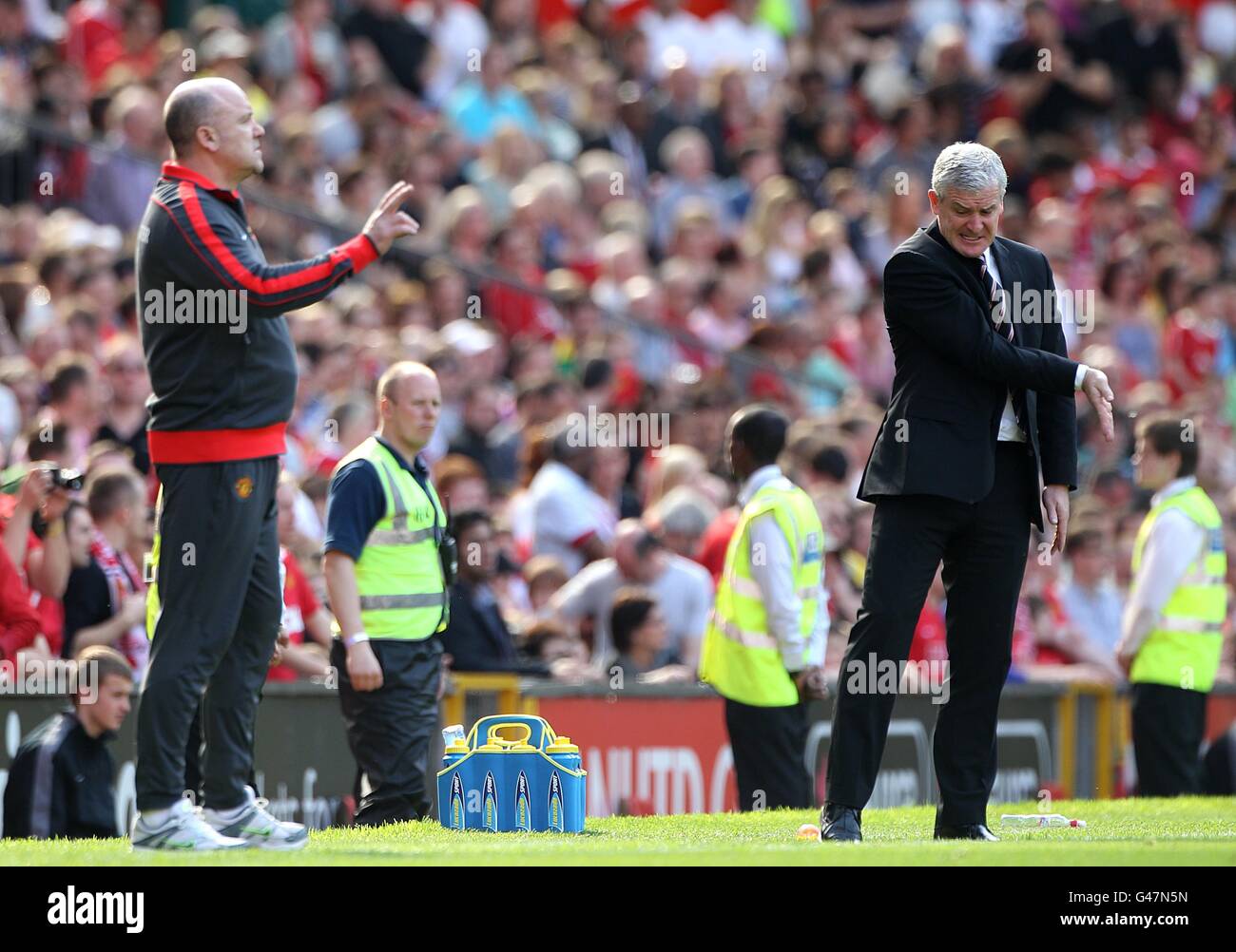 Soccer - Barclays Premier League - Manchester United v Fulham - Old Trafford. Fulham manager Mark Hughes (right) and Manchester United assistant manager Mike Phelan (left) on the touchline Stock Photo