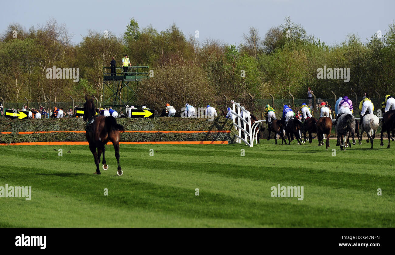 The remaining runners in the Grand National are directed around Bechers