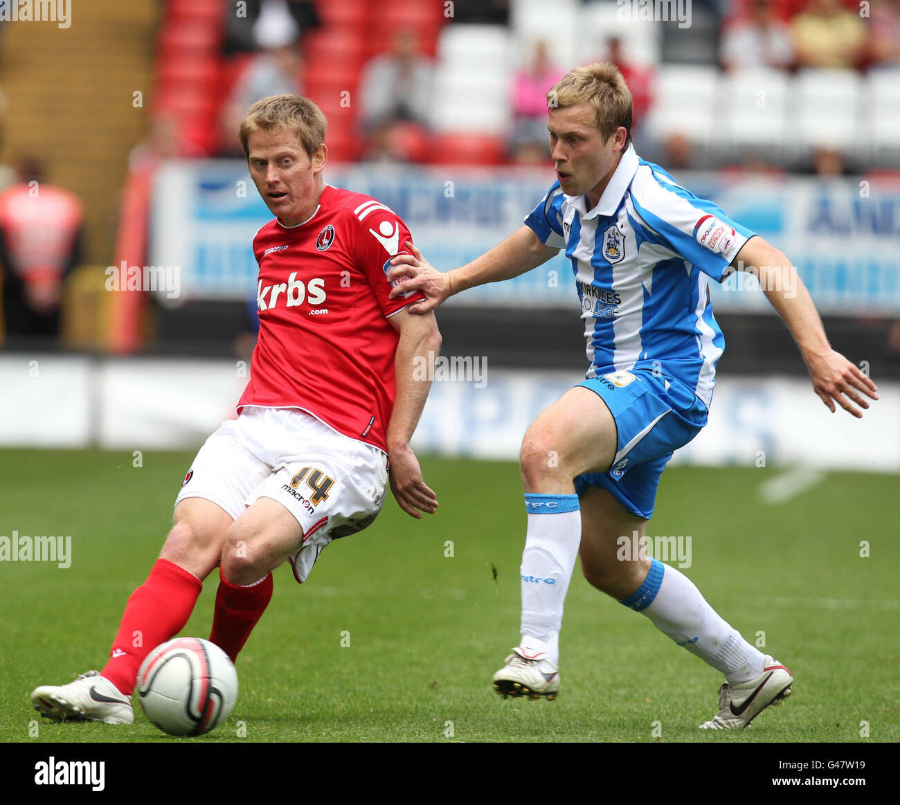 Charlton Athletic's Michael Stewart is challenged by Huddersfield Town's Scott Arfield during the npower Football League One match at The Valley, London. Stock Photo