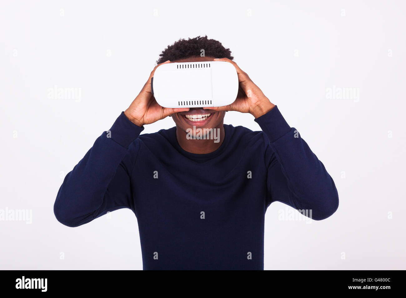 African American young man wearing vr virtual reality headset over ...