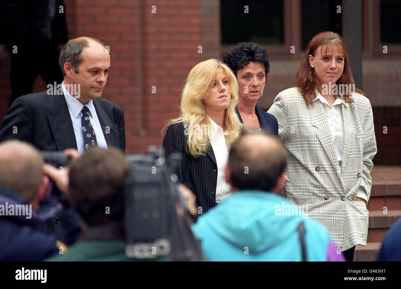 Tracie Andrews (centre left) faces the media pack as she leaves Birmingham Crown Court today (Monday) with her mother Irene Carter (centre right), sister Donna Carter and step father Alan Carter. Miss Andrews is charged with the murder of her boyfriend Lee Harvey. Picture by DAVID JONES/PA. See PA story COURTS Tracie Stock Photo