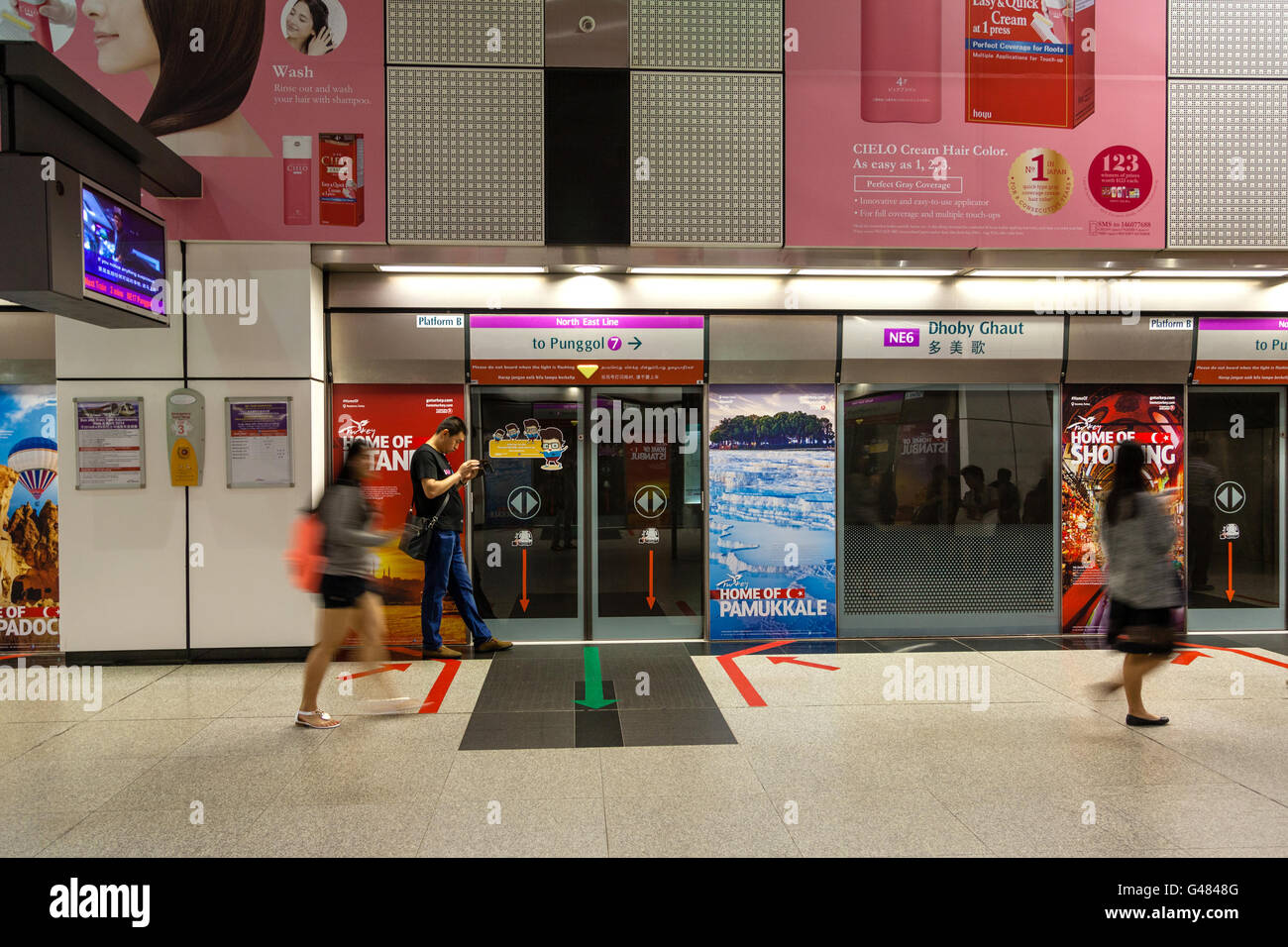 Singapore, Singapore - December 10, 2014: People waiting at the Dhoby Ghaut MRT Station in Singapore. Stock Photo