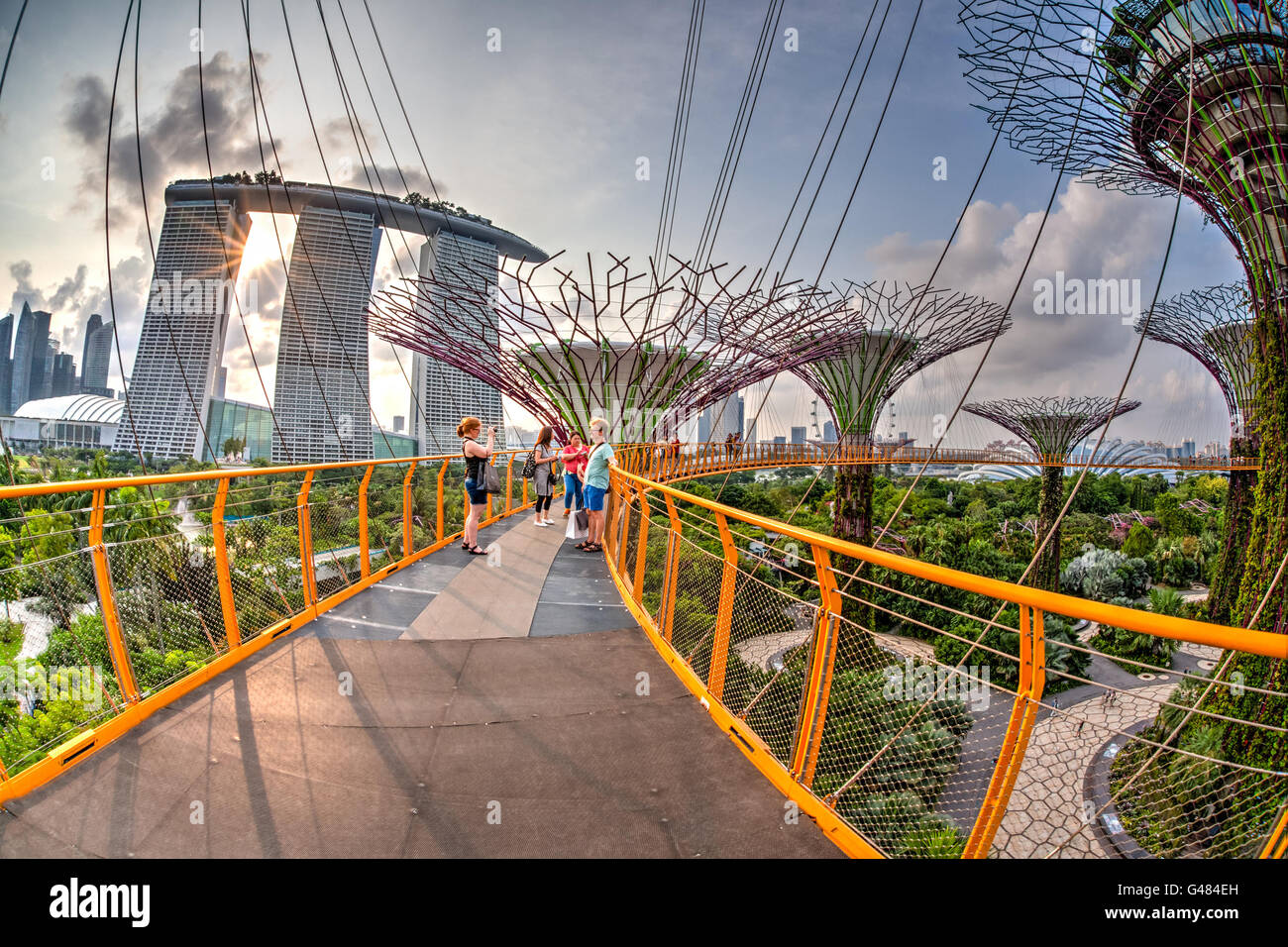 Singapore, Singapore - July 13, 2015: Visitors enjoying the sunset view atop the Supertree Grove at Gardens by the Bay. These ma Stock Photo