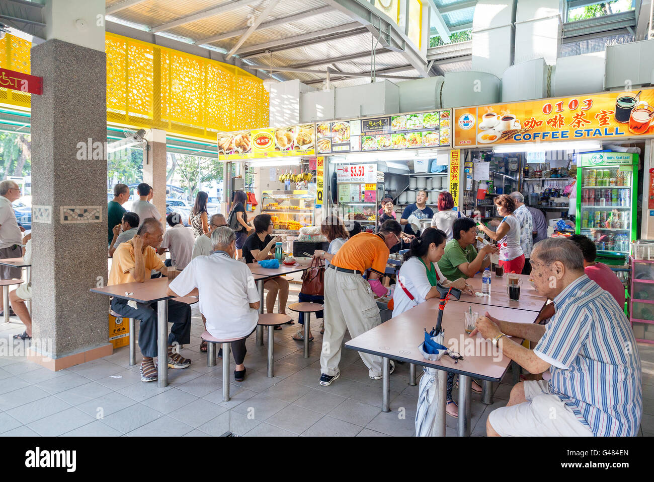 Singapore, Singapore - December 11, 2014: Diners eat at the popular food stalls in Whampoa Hawker Center in Singapore. Stock Photo