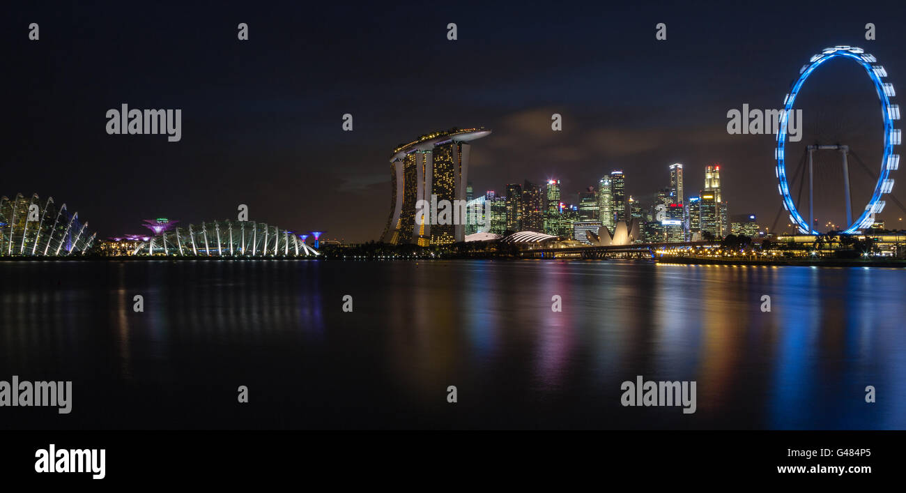 A panorama of Singapore's skyline at night on the Marina Bay. Stock Photo