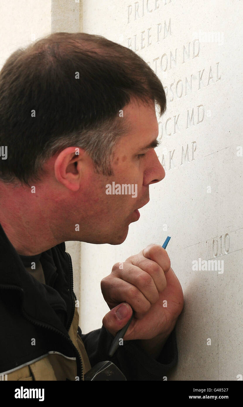 Nick Hindle prepares to engrave the names of 112 UK Servicemen and women who were killed on duty or through terrorism in 2010 at The National Memorial Arboretum in Alrewas, Staffordshire. Stock Photo