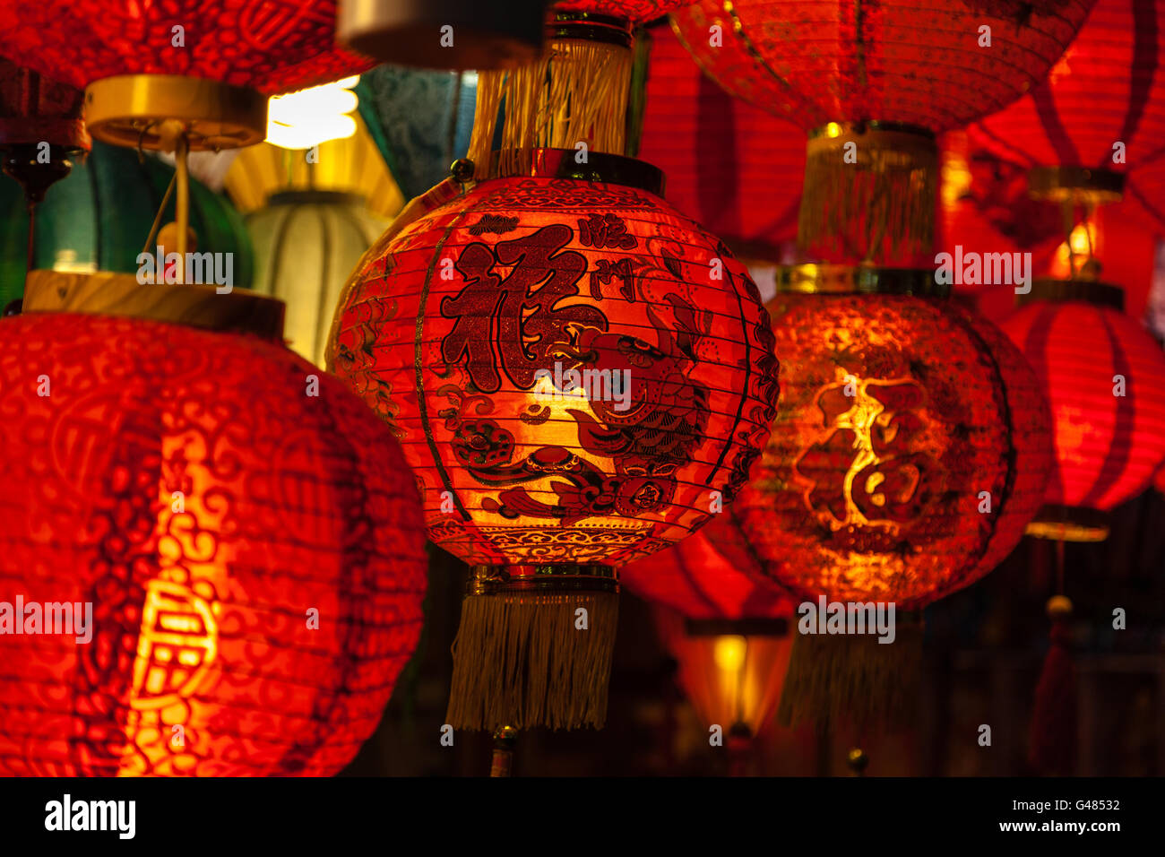 Focus on a Chinese lantern with the words "Blessings" printed on it among an array of red lanterns in the background. Stock Photo