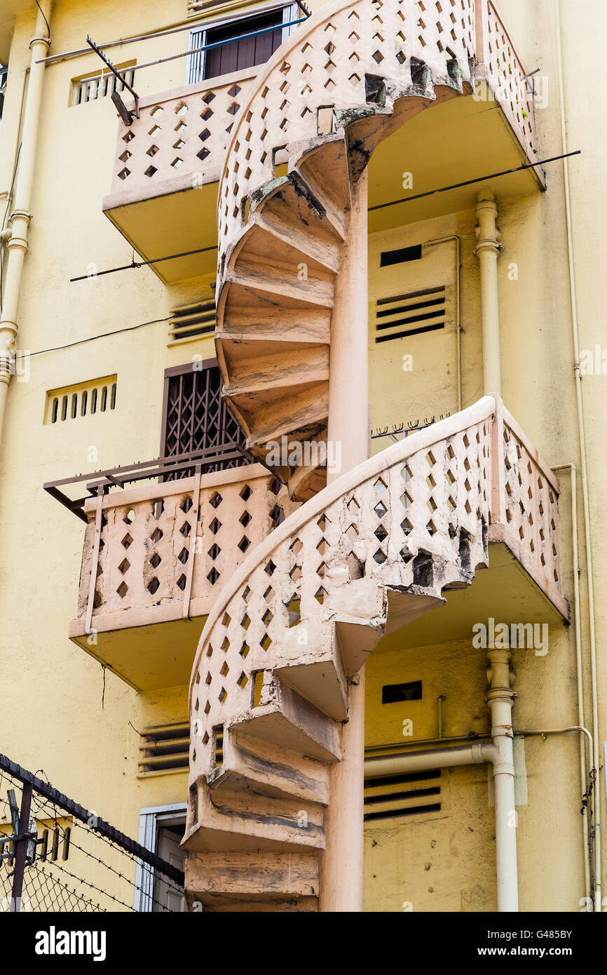 Back alley Victorian-style spiral staircase of an old colonial building in Singapore. Stock Photo