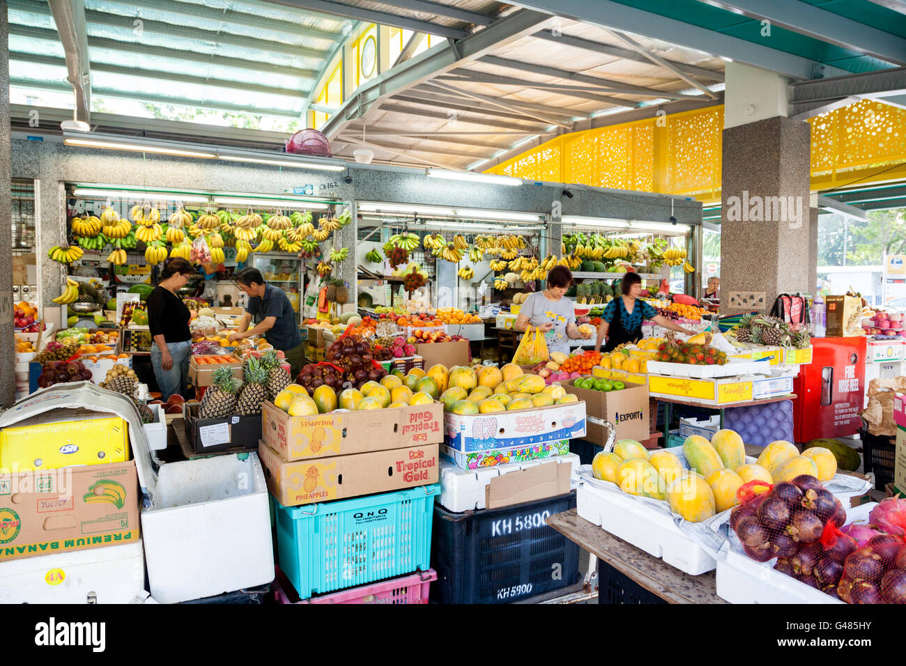 Singapore, Singapore - December 11, 2014: Local residents shopping for fruits and vegetables at a local wet market in Singapore. Stock Photo