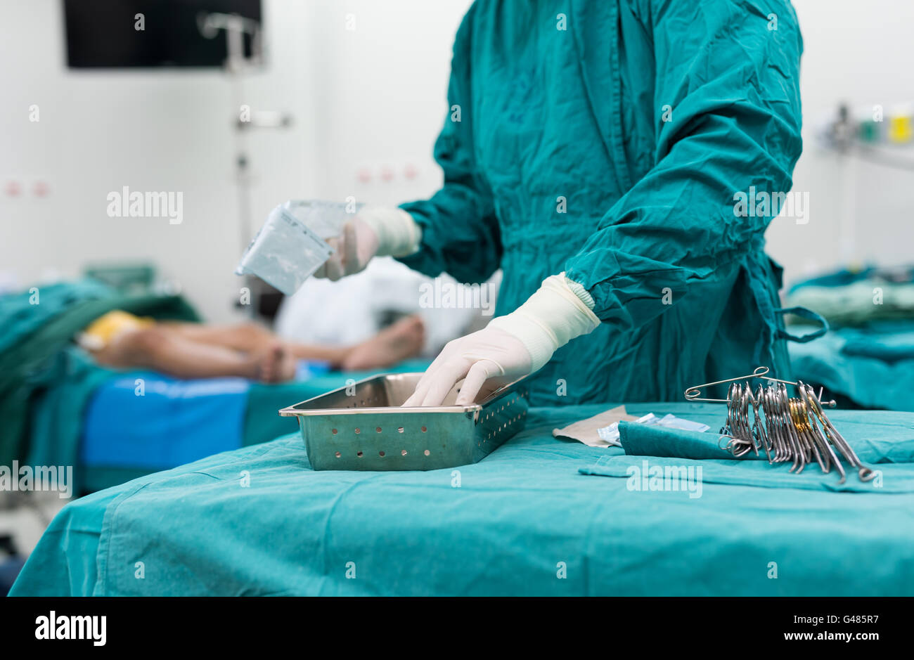 scrub nurse preparing medical instruments for operation Stock Photo