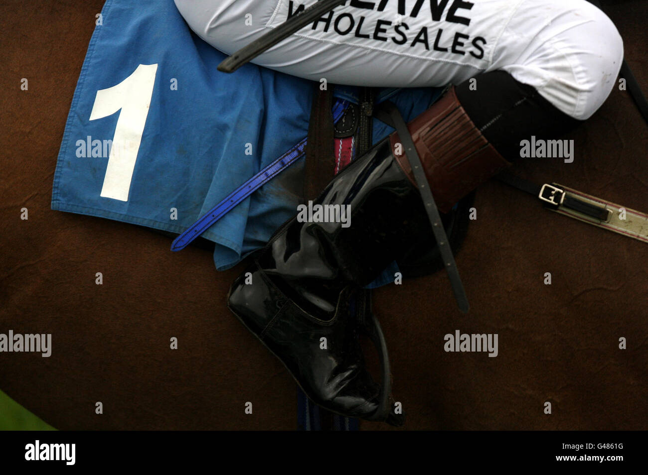 Detailed view saddle cloth number 1 on jockeys boots hires stock