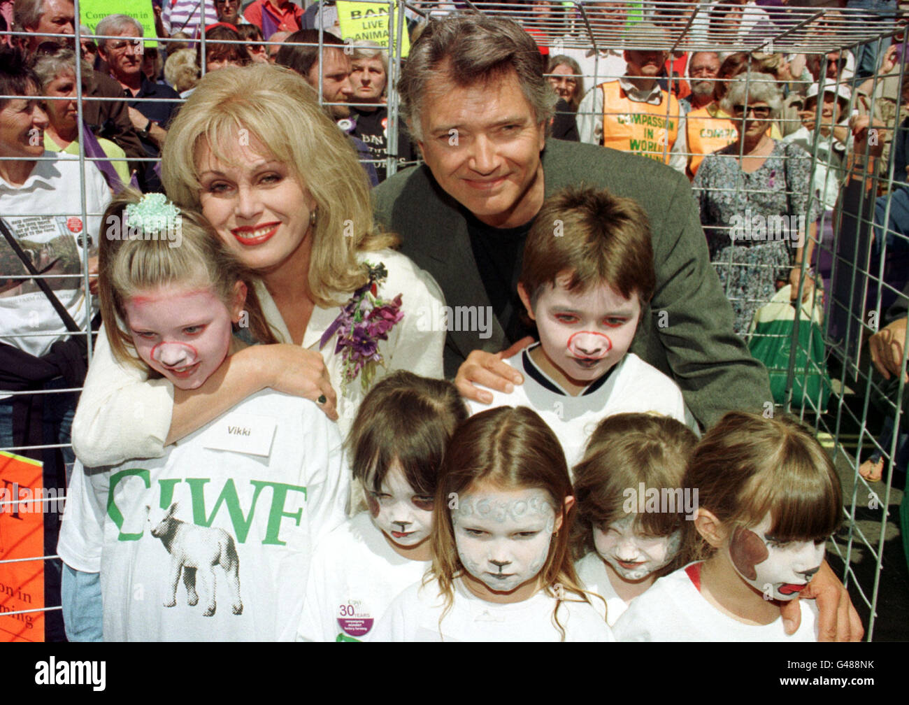 Actress Joanna Lumley and actor Martin Shaw with children who were placed in a cage to signify the suffering of some animals in the world of agriculture. The demonstration marked the 30th anniversary of the organisation 'Compassion in World Farming'. Stock Photo