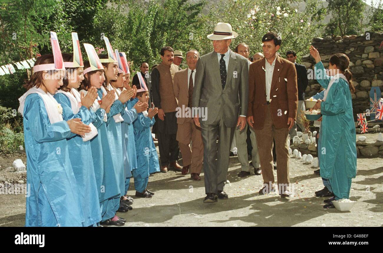 The Duke of Edinburgh showered in flower petals, receives a warm and colourful welcome from Chitrali children at the Aga Khan School in Bilphok, North West Frontier Province, Pakistan. Stock Photo