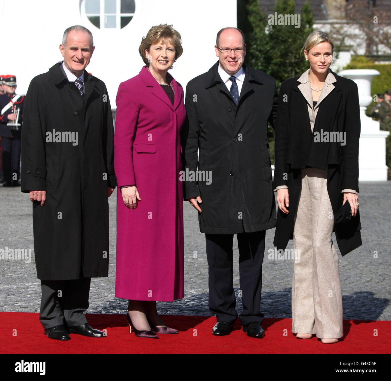 Prince Albert II of Monaco and his fiancee Charlene Whittstock are greeted by Irish President Mary McAleese and her husband Martin at Aras an Uachtarain. Stock Photo