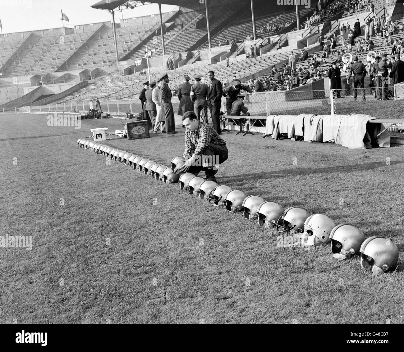 All ready for the match, a line of helmets are placed ready by J. Hanrahan, of Pennsylvania, the Team Manager of the London Rockets. Stock Photo