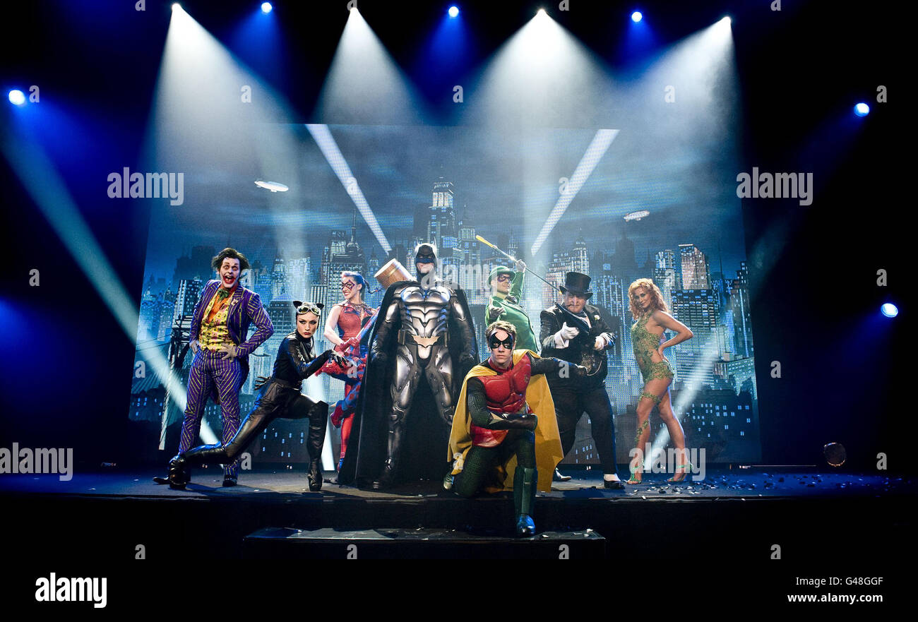 People in costume as the characters (left - right) The Joker, Catwoman, Harley Quinn, Batman, Robin (front), The Riddler, The Penguin Poison Ivy which who will feature in the Batman Live Worldwide Arena tour as they attend a photocall at the Royal Horticultural Halls in London. Stock Photo