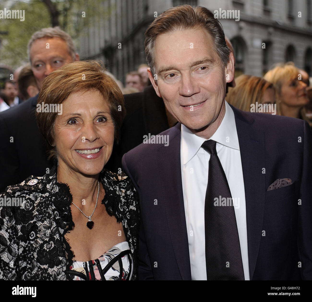 Anthony Andrews and wife Georgina Simpson arrive at The Novello Theatre, The Aldwych, London, for the press night of Betty Blue Eyes. Stock Photo