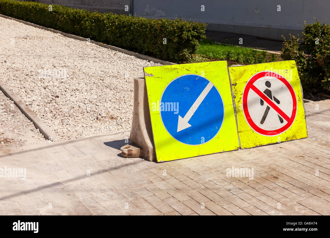 Road signs at the under construction sidewalk in summer day Stock Photo ...