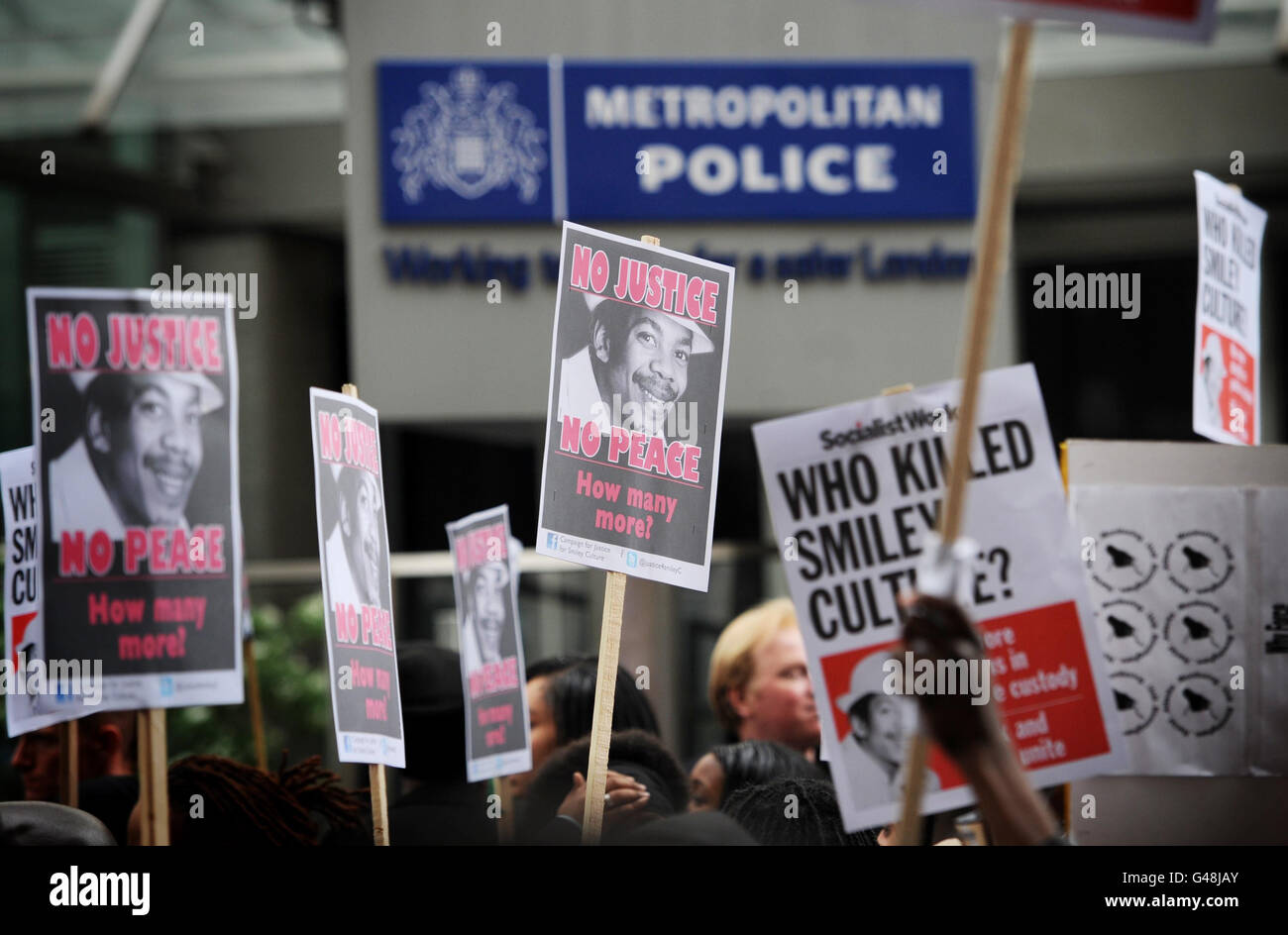 Demonstrators outside New Scotland Yard march in protest of the death of David Emmanuel (also known as Smiley Culture) who died during a raid on his home in Surrey last month. Stock Photo