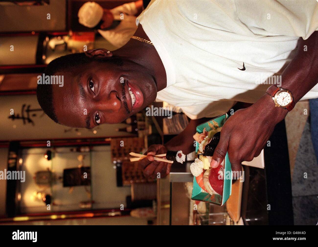 American record-breaking athlete, Michael Johnson, takes time out for a snack in the sushi bar at Harrods department store in London today (Saturday), before he heads the bill in tomorrow's three-cornered Spar British Challenge at Crystal Palace. Photo by Tony Harris. See PA Story ATHLETICS Johnson. Stock Photo