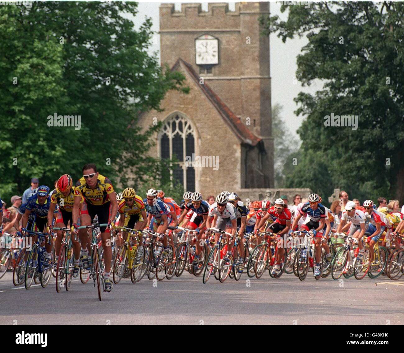 A field of cyclists pass Headcorn Church, Kent during the Rochester ...