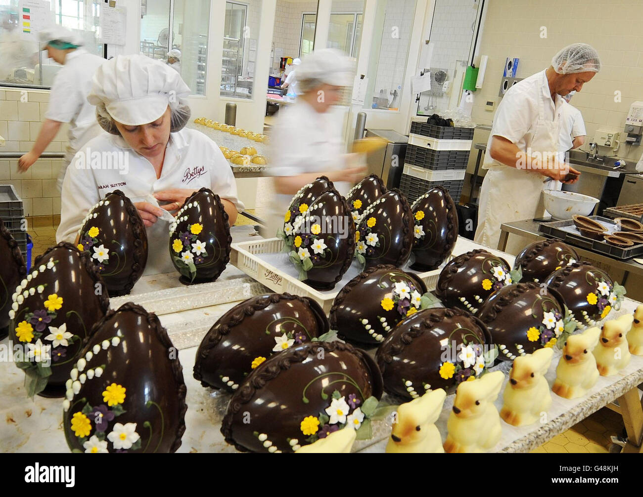 Chocolatiers work on the hand-crafted chocolate Easter eggs and rabbits at Betty's in Harrogate before the Easter weekend. Stock Photo