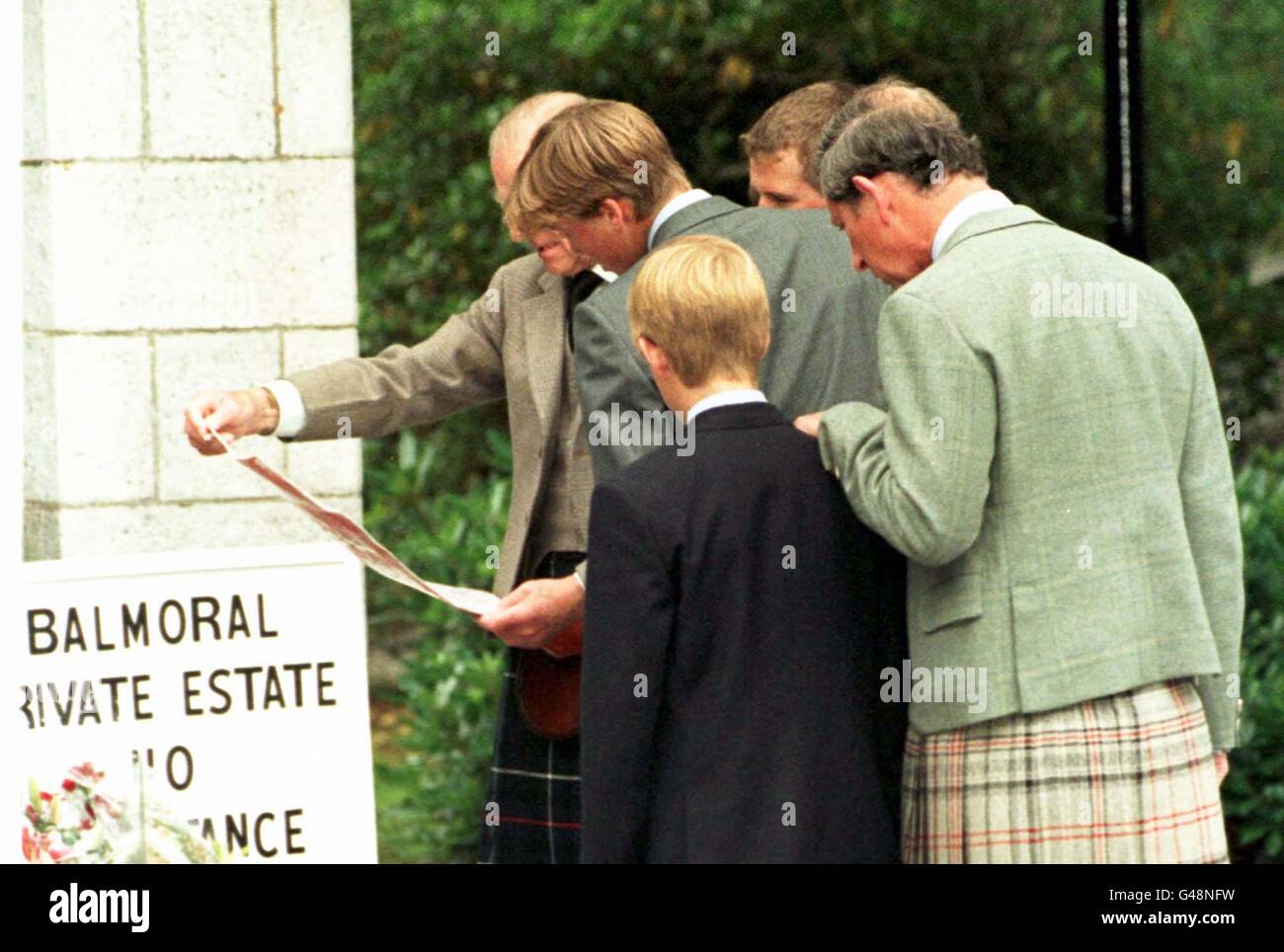 Members of the Royal family look at floral tributes and read messages of condolence outside Balmoral Castle. Photo by Chris Bacon/PA Stock Photo