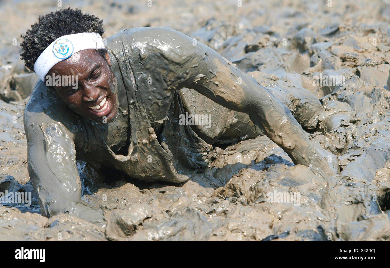 Blue Peter presenter Andy Akinwolere finishes the annual Maldon Mud Race on the river Blackwater in Maldon. Stock Photo